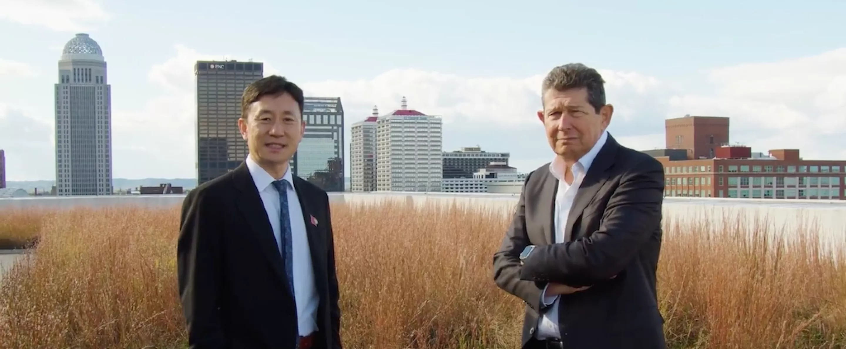 Jiapeng Huang and Jon Klein in front of the Louisville skyline