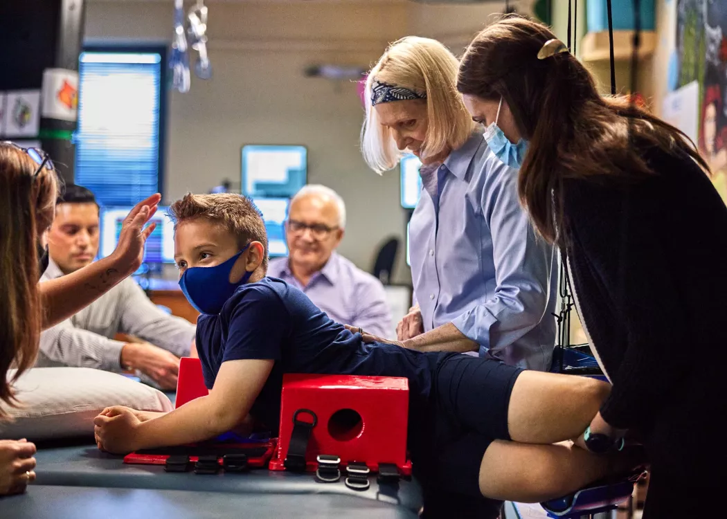 Andrea Behrman is doing research on and analyzing a child's spinal cord.