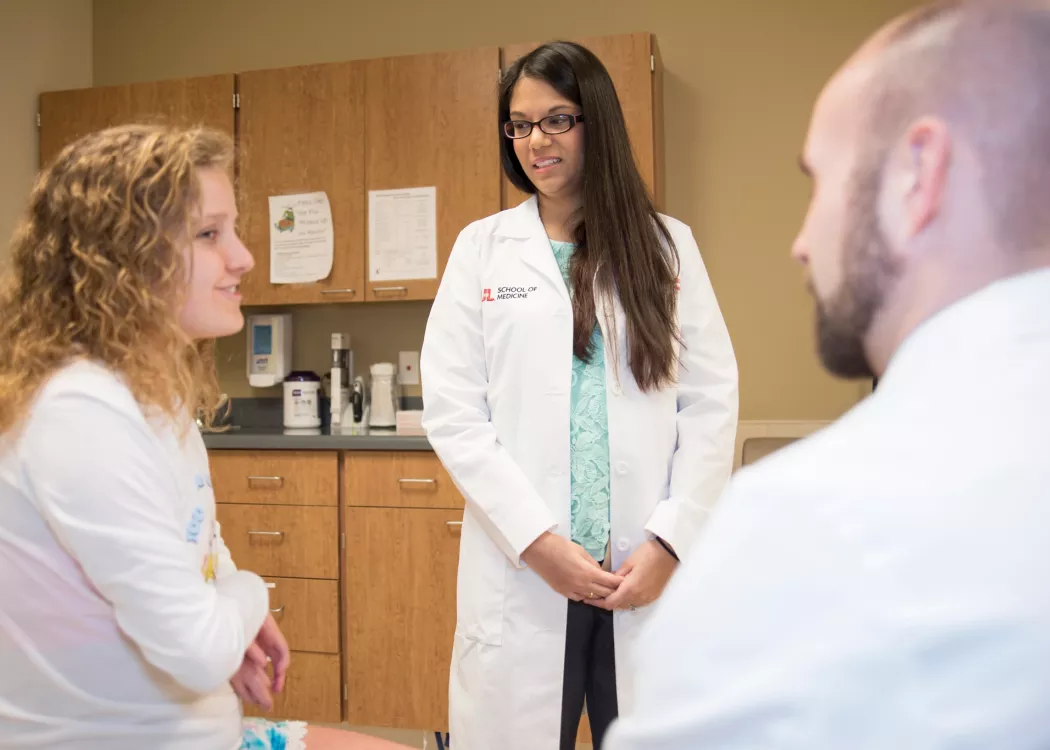 Medical students listen to a patient at the Lee Clinic